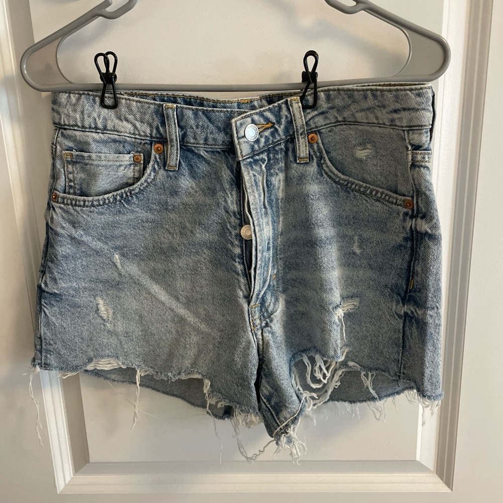 Vintage distressed high waisted blue denim shorts.